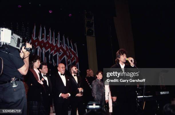 British Rock and Pop musician George Harrison speaks onstage during his induction, as a member of the group the Beatles, at the Rock and Roll Hall of...