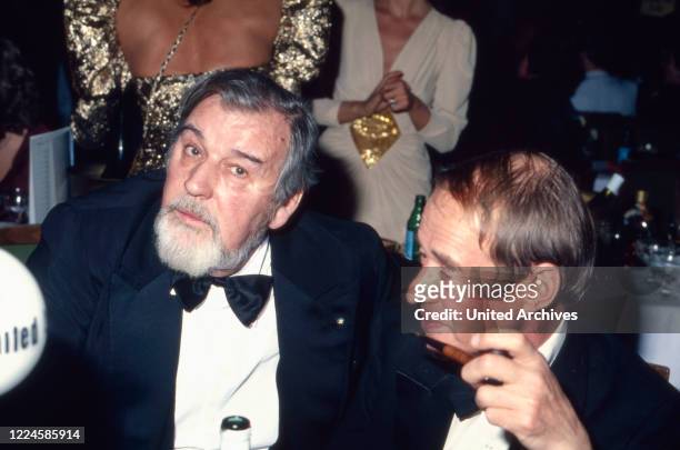 German film producer, director and actor Bernhard Wicki with film producer Franz Seitz Jr, Germany 1980s.
