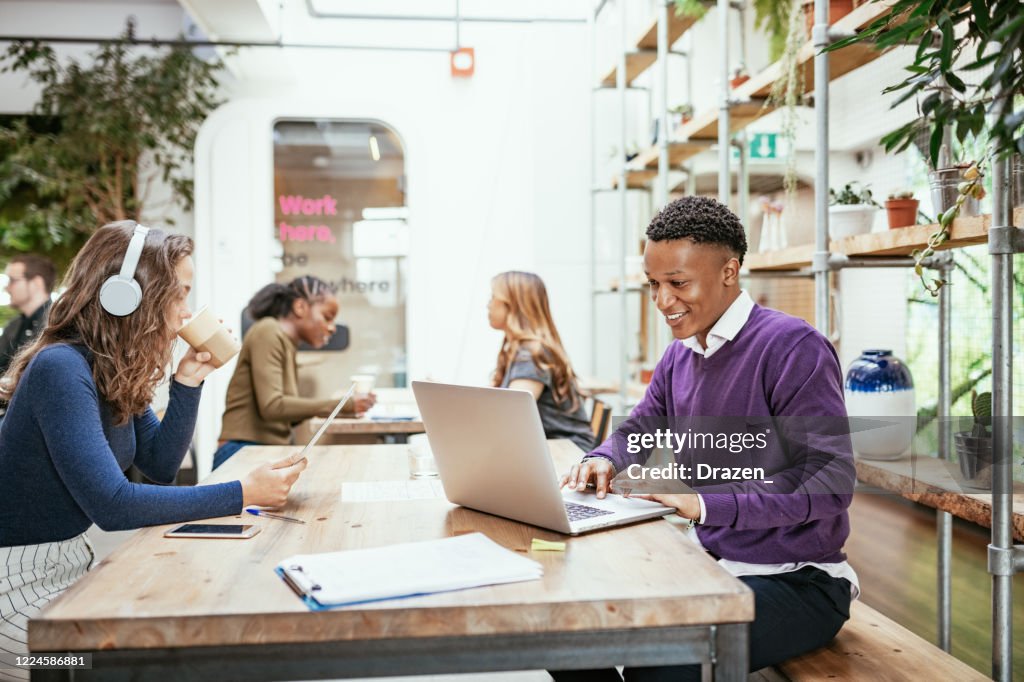 Diverse business people telecommuting from cafe