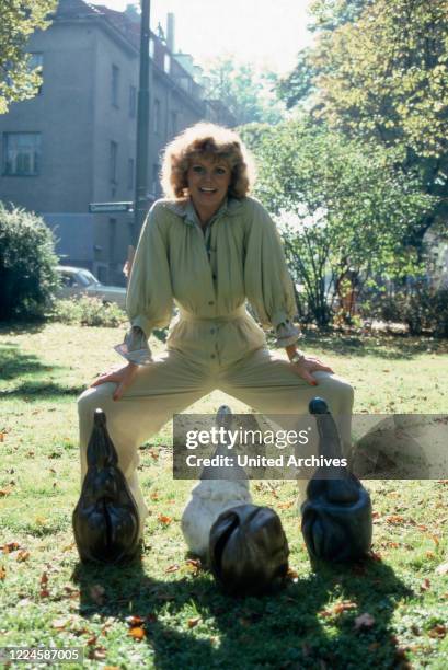 German actress Christiane Ruecker in the garden with penis and vagina sculptures, Germany, 1970s.