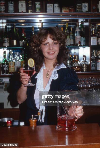 German actress Michaela May at the bar of Sonnenhof hotel, Germany, 1970s.