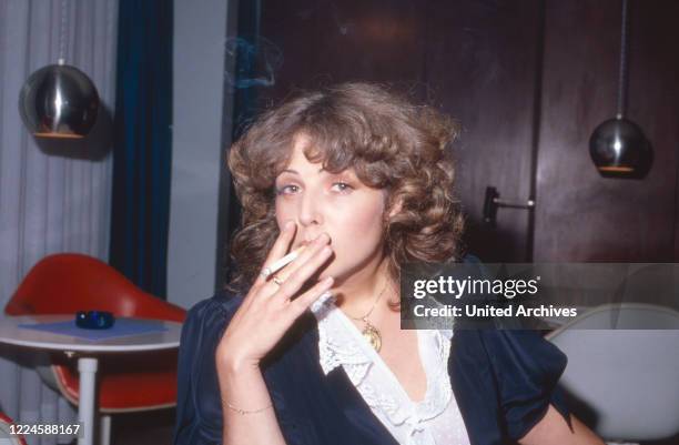 German actress Michaela May having a cigarette, Germany, 1970s.