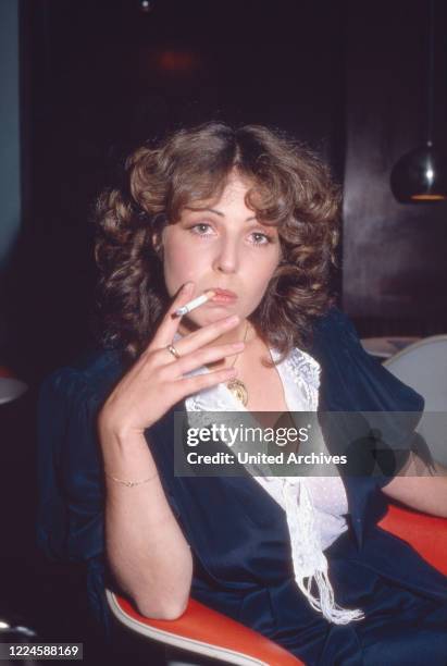 German actress Michaela May having a cigarette, Germany, 1970s.