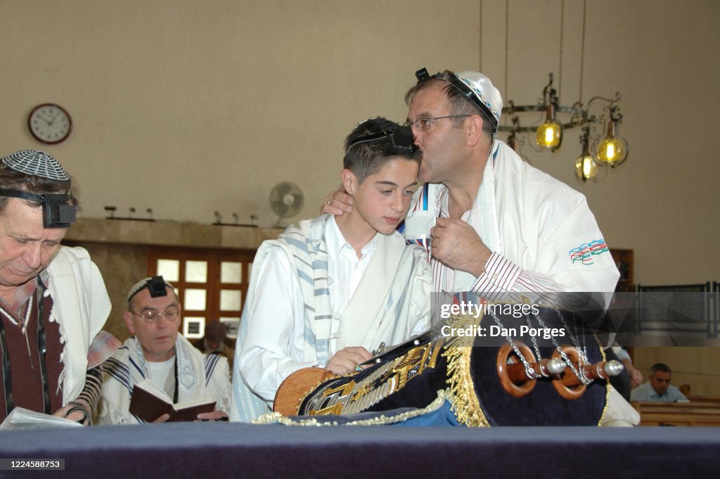 Bar Mitzvah boy is kissed by his father
