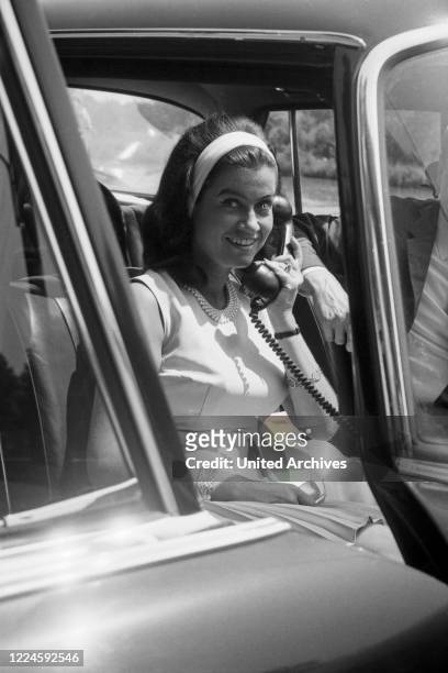 Singers Dagmar Hank on the phone in a car, Germany, 1960s.