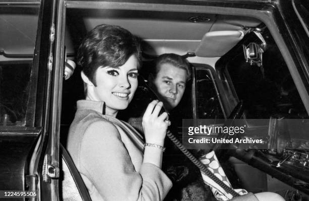 Canadian actress Beverly Adams and driver Otto Maurer in Munich, Germany, 1960s.