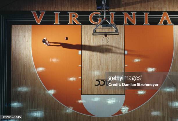 Dawn Staley,Guard for the University of Virginia Cavaliers women's basketball team casts a shadow across the court as she practices making a shot...