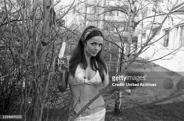 Photo model Chriss Camerer wearing a bikini at a photo shoot, Germany, 1960s.