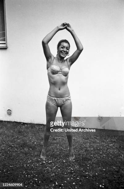 Photo model Marielle doing a photo shoot wearing swimsuit, Germany, 1960s.