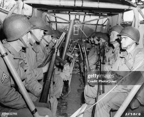 Members of the 101st Airborne Division sit in a glider as they await take off from RAF base Greenham Common during maneuvers in preparation for the...