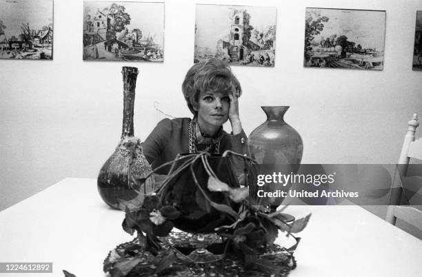 German actress Grit Boettcher in the living room, Germany, 1960s.