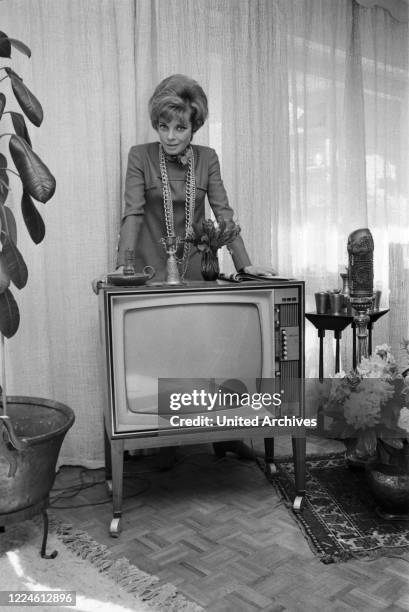 German actress Grit Boettcher in the living room, Germany, 1960s.