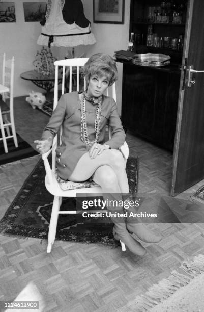 German actress Grit Boettcher in the living room, Germany, 1960s.