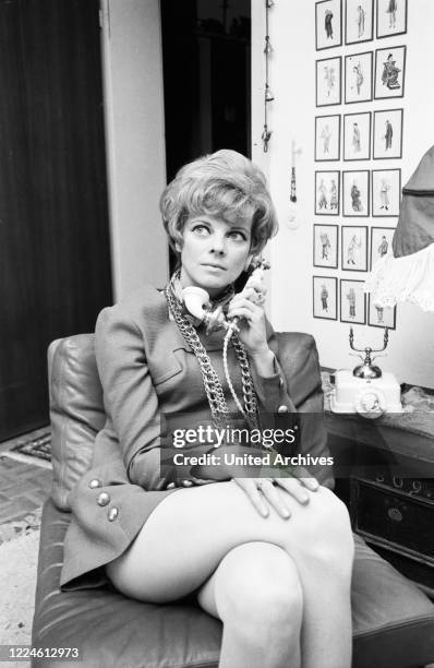 German actress Grit Boettcher in the living room, Germany, 1960s.