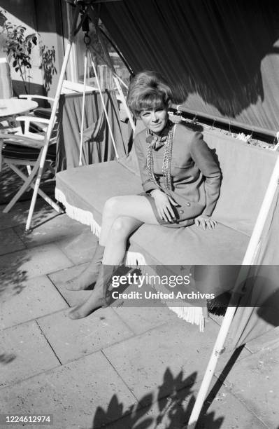 German actress Grit Boettcher in the living room, Germany, 1960s.