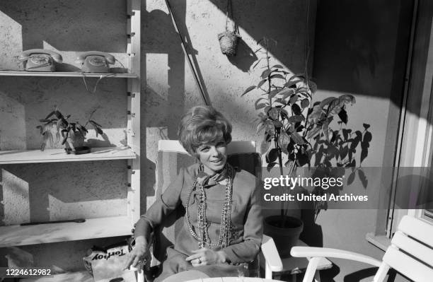 German actress Grit Boettcher in the living room, Germany, 1960s.