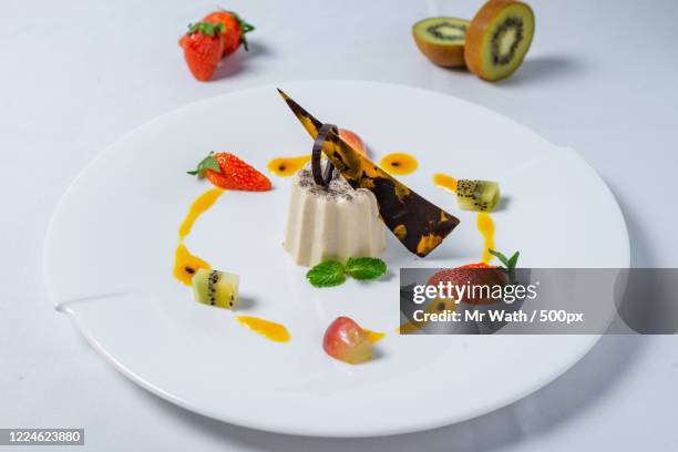 white chocolate and black pepper panna cotta - panna cotta stock pictures, royalty-free photos & images