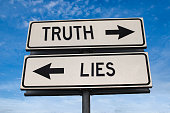 Truth vs lies. White two street signs with arrow on metal pole with word