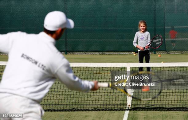 Phil Spencer, Cheshire coach of the year 2019 photographed in action at the Bowdon Lawn Tennis Club coaching 9-year-old club member Gigi Welch, today...