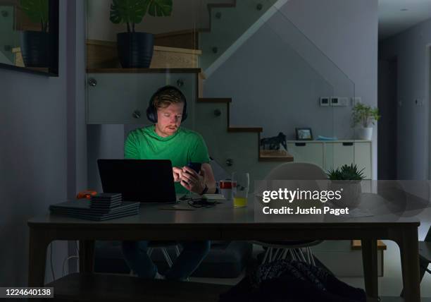 man working from home in the evening - makeshift office stock pictures, royalty-free photos & images