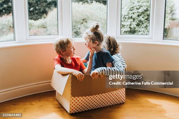 kids in a box - inside of a home stock pictures, royalty-free photos & images