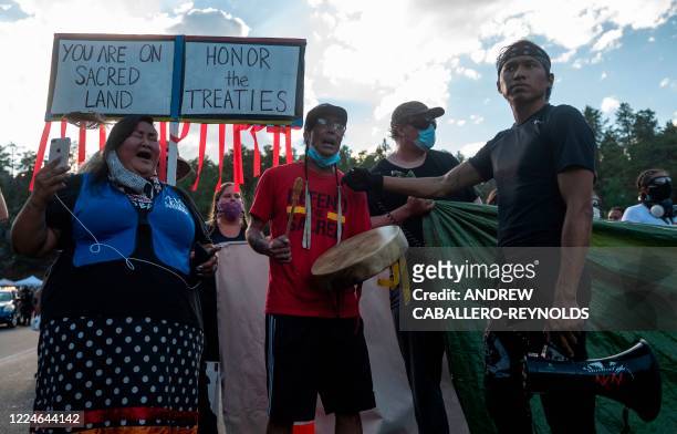 Activists and members of different tribes from the region block the road to Mount Rushmore National Monument as they protest in Keystone, South...