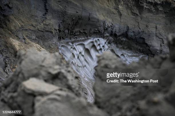 Permafrost, seen at the top of the cliff, melts into the Kolyma River, Siberia, Russia on July 6, 2019. The permafrost, some of which is tens of...