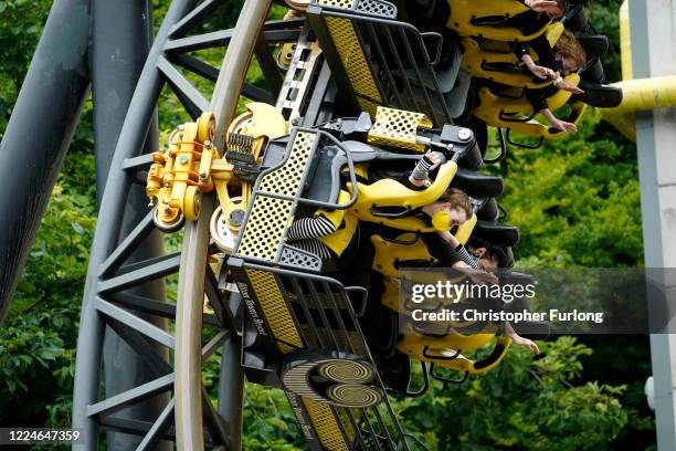 Members of the public wear masks as they ride "The Smiler" rollercoaster at Alton Towers on July 4, 2020 in Alton, England. The popular theme park...