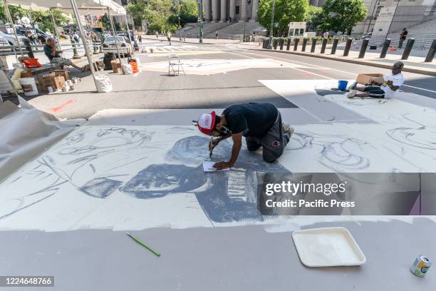 Centre Street painted with Black Lives Matter murals by artists and volunteers in front of Federal Court house. Mayor de Blasio announced that every...