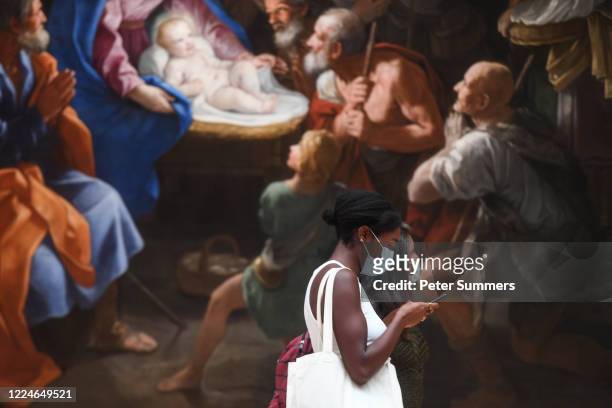 Women are seen wearing masks while viewing paintings at the National Portrait Gallery during a press preview ahead of the gallery's reopening on July...