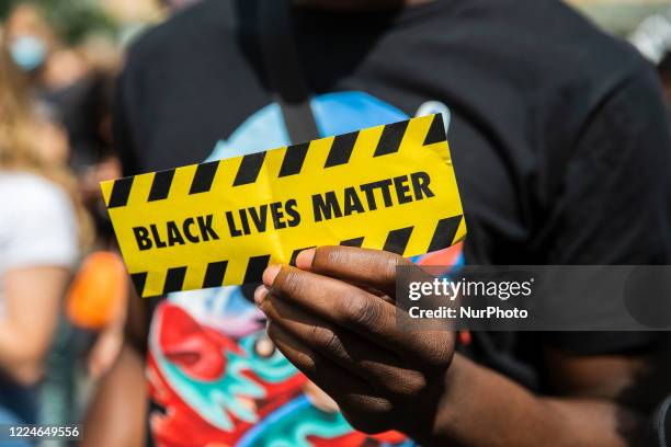 People protest against racism and police brutality and pay tribute to George Floyd at Gendarmenmarkt in Berlin, Germany on July 4, 2020.