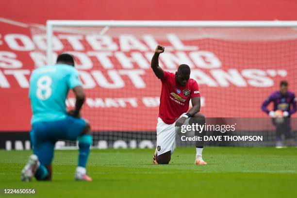 Manchester United's French midfielder Paul Pogba takes a knee to show support for the Black Lives Matter movement and protest against racism during...
