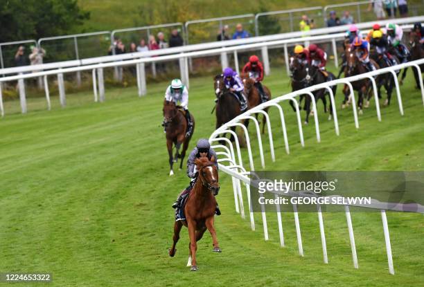 Jockey Emmet McNamara rides Serpentine into a clear lead around Tattenham Corner on their way to victory in the Derby Stakes at the Epsom Derby...