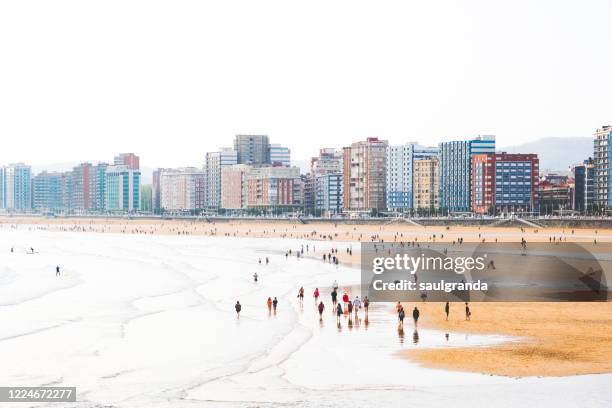 urban beach at low tide - gijon stock pictures, royalty-free photos & images