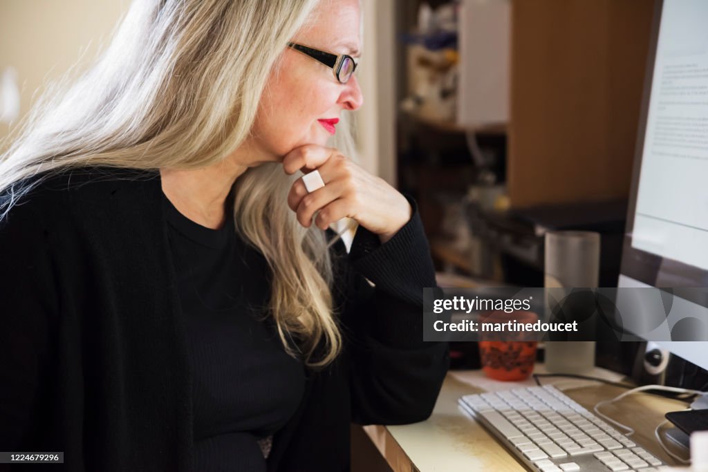 Stylish 50+ woman working from home.