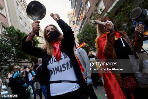 Groups of people participate with Spanish flags, hitting saucepans and shouts calling for the resignation of the government and against the...