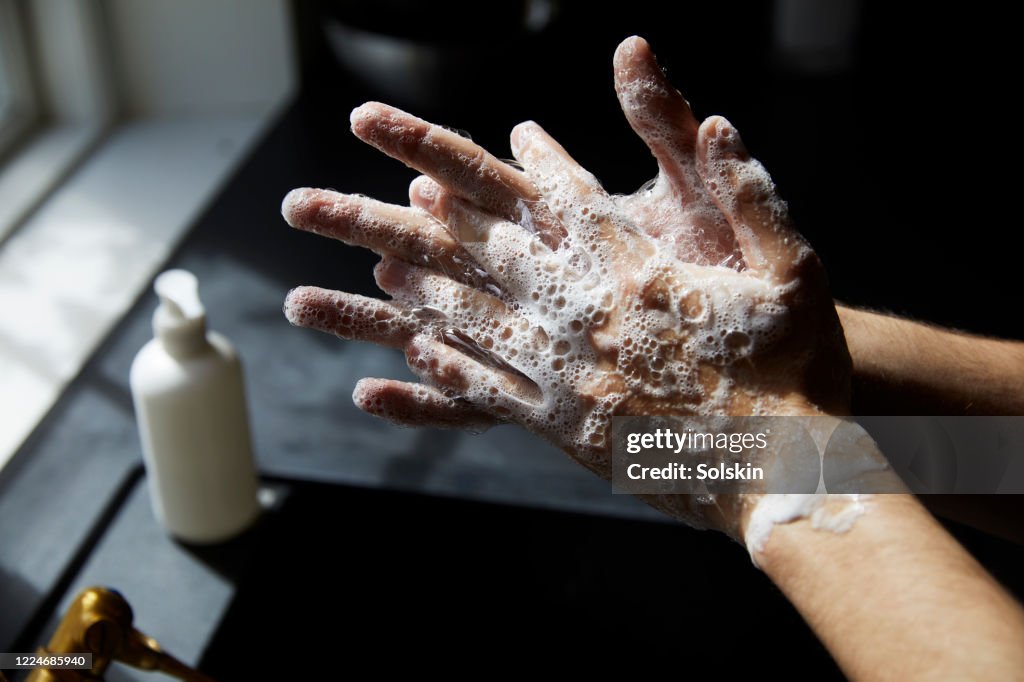 Young man washing hands