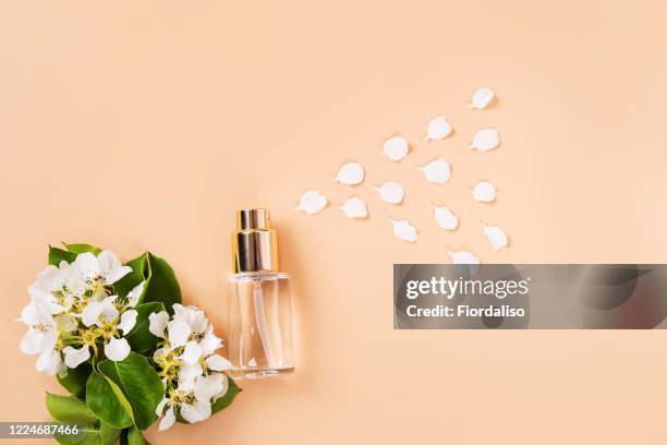 bottle and flowers - spray bottle stock-fotos und bilder