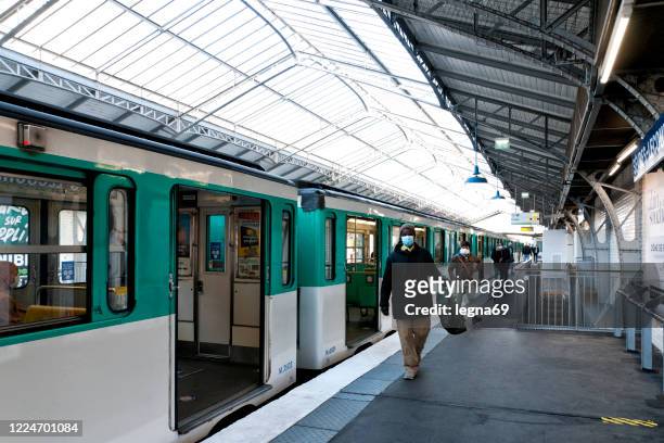 paris : people go out of the car 's subway, wearing mask, few days after the covid19 lockdown - door canopy stock pictures, royalty-free photos & images