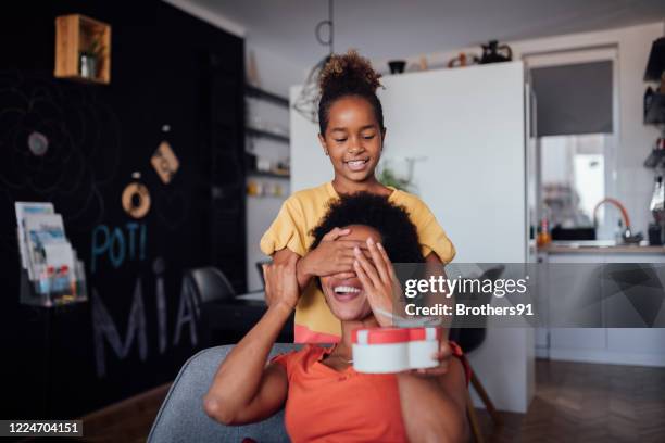 beautiful little girl giving her mother a mother's day present - hands covering eyes stock pictures, royalty-free photos & images