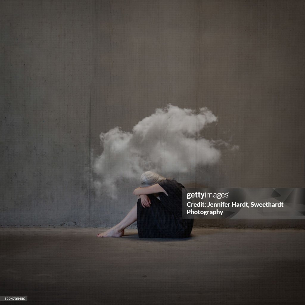 Manipulated photo of a woman on ground looking away from camera head covered in a cloud
