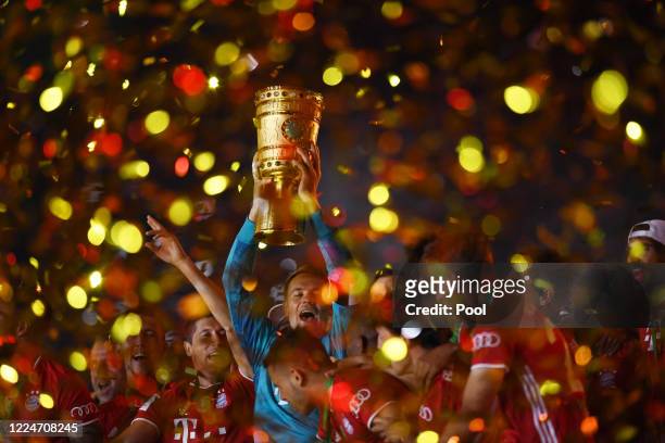 Manuel Neuer, Captain of Bayern Munich lifts the trophy as they celebrate following victory in the DFB Cup final match between Bayer 04 Leverkusen...