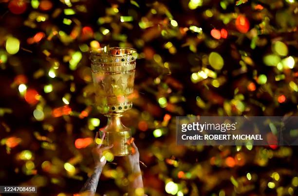 Bayern Munich's players celebrate with the German Cup trophy after winning the final football match Bayer 04 Leverkusen v FC Bayern Munich at the...