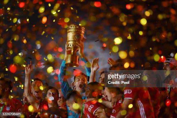 Bayern Munich's Manuel Neuer celebrates with the trophy after winning the DFB Cup during the DFB Cup final match between Bayer 04 Leverkusen and FC...