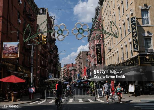People dine al fresco in Little Italy on Mulberry Street between Hester and Broome Streets on July 4, 2020 in the Manhattan borough of New York City....