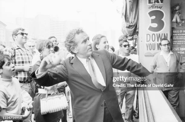 American novelist, journalist, essayist, playwright, film-maker, actor, and social activist Norman Mailer , center figure, suit and tie, throwing...