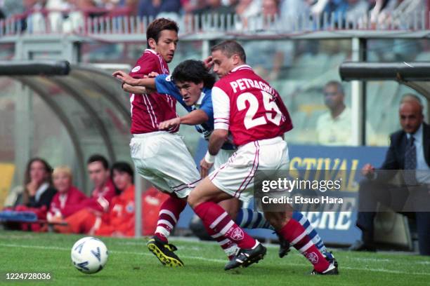 Ariel Ortega of Sampdoria competes for the ball against Hidetoshi Nakata and Gianluca Petrachi of Perugia in action during the Serie A match between...