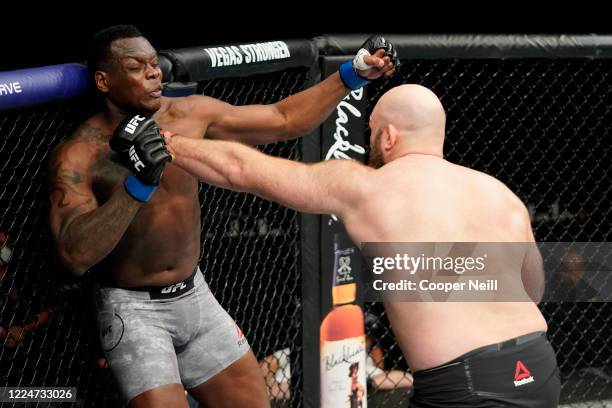 Ben Rothwell punches Ovince Saint Preux in their heavyweight bout during the UFC Fight Night Event at VyStar Veterans Memorial Arena on May 13, 2020...