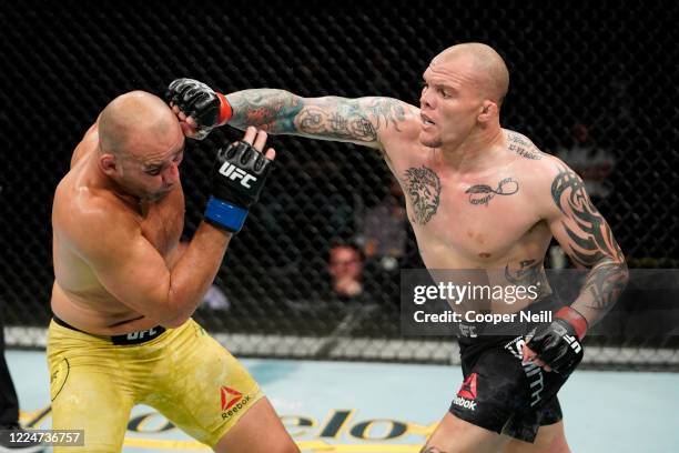 Anthony Smith punches Glover Teixeira of Brazil in their light heavyweight bout during the UFC Fight Night Event at VyStar Veterans Memorial Arena on...