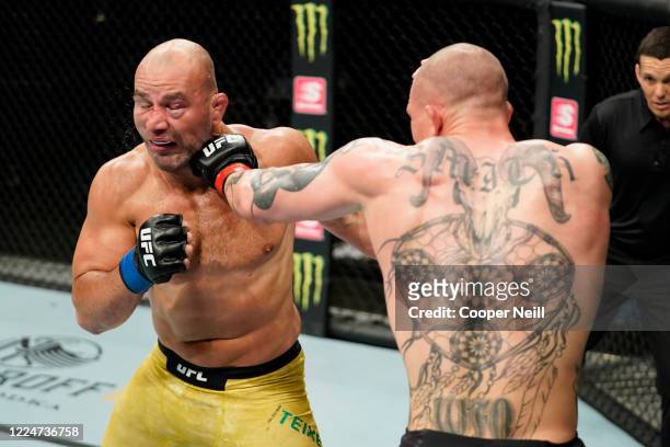Anthony Smith punches Glover Teixeira of Brazil in their light heavyweight bout during the UFC Fight Night Event at VyStar Veterans Memorial Arena on...
